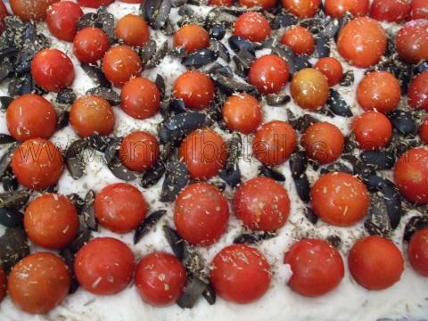 Focaccia de tomatitos y aceitunas, lista para ser horneada